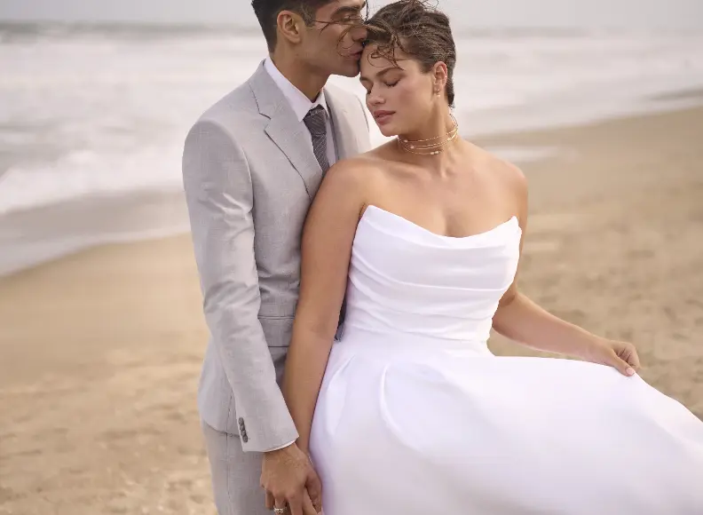 Models On The Beach Holding Hands With One Wearing Simple A Line Wedding Dress Called Maureen By Maggie Sottero