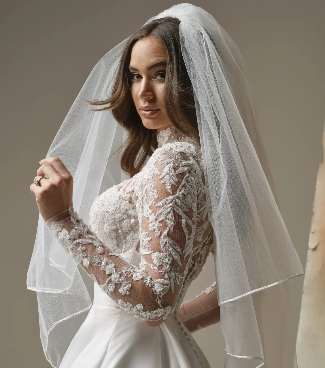 Model Holding A Veil Wearing Soutache Edge Veil By Maggie Sottero