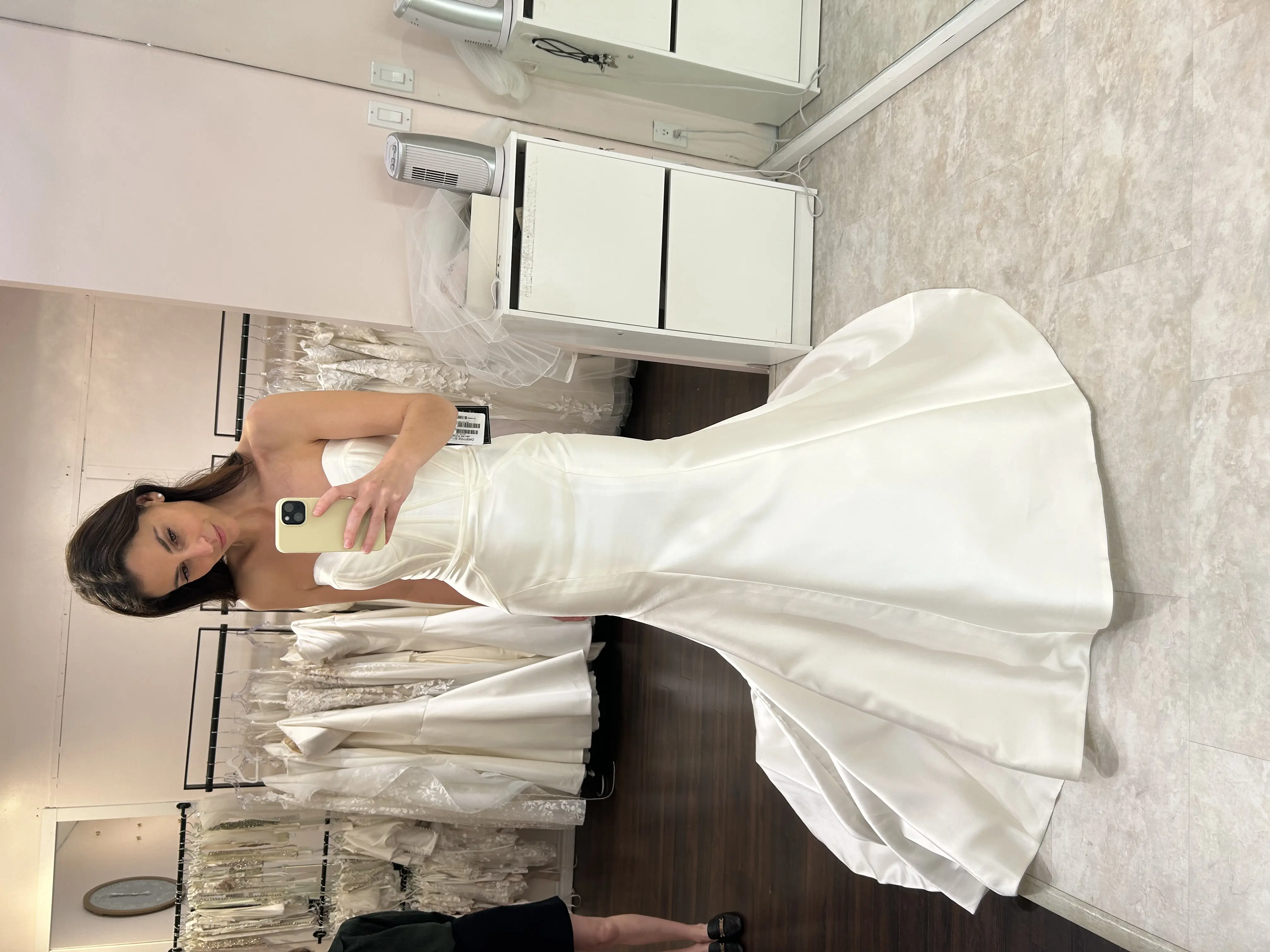 Bride Trying On A White Wedding Dress Named Missy By Rebecca Ingram