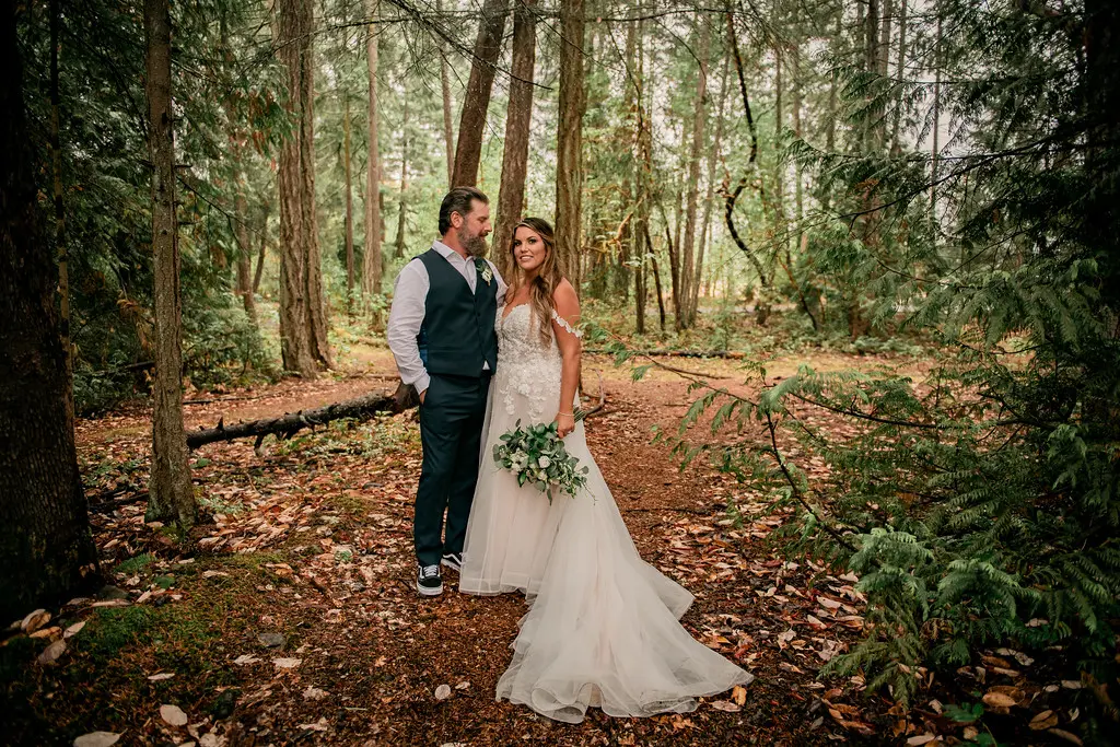 Bride wearing Boho Wedding Dress called Stevie by Maggie Sottero in the forest with her groom