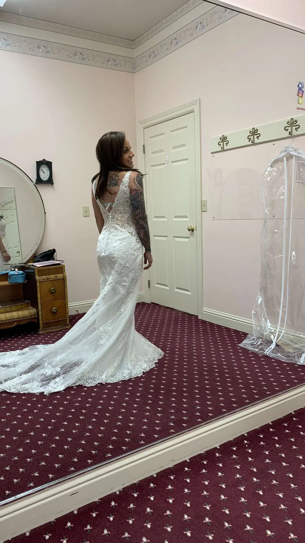 Bride trying on Sheath Wedding Dress called Delilah by Maggie Sottero in a boutique