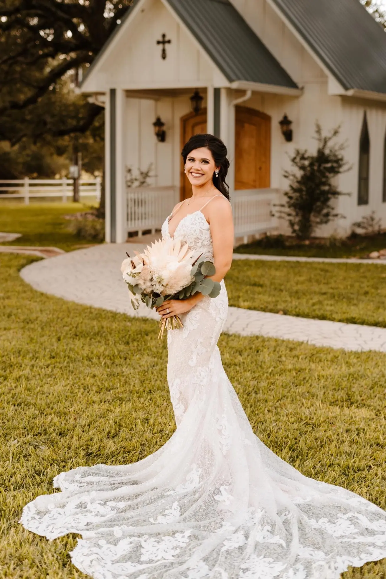 Bride wearing sparkly lace sheath fit and flare wedding dress.