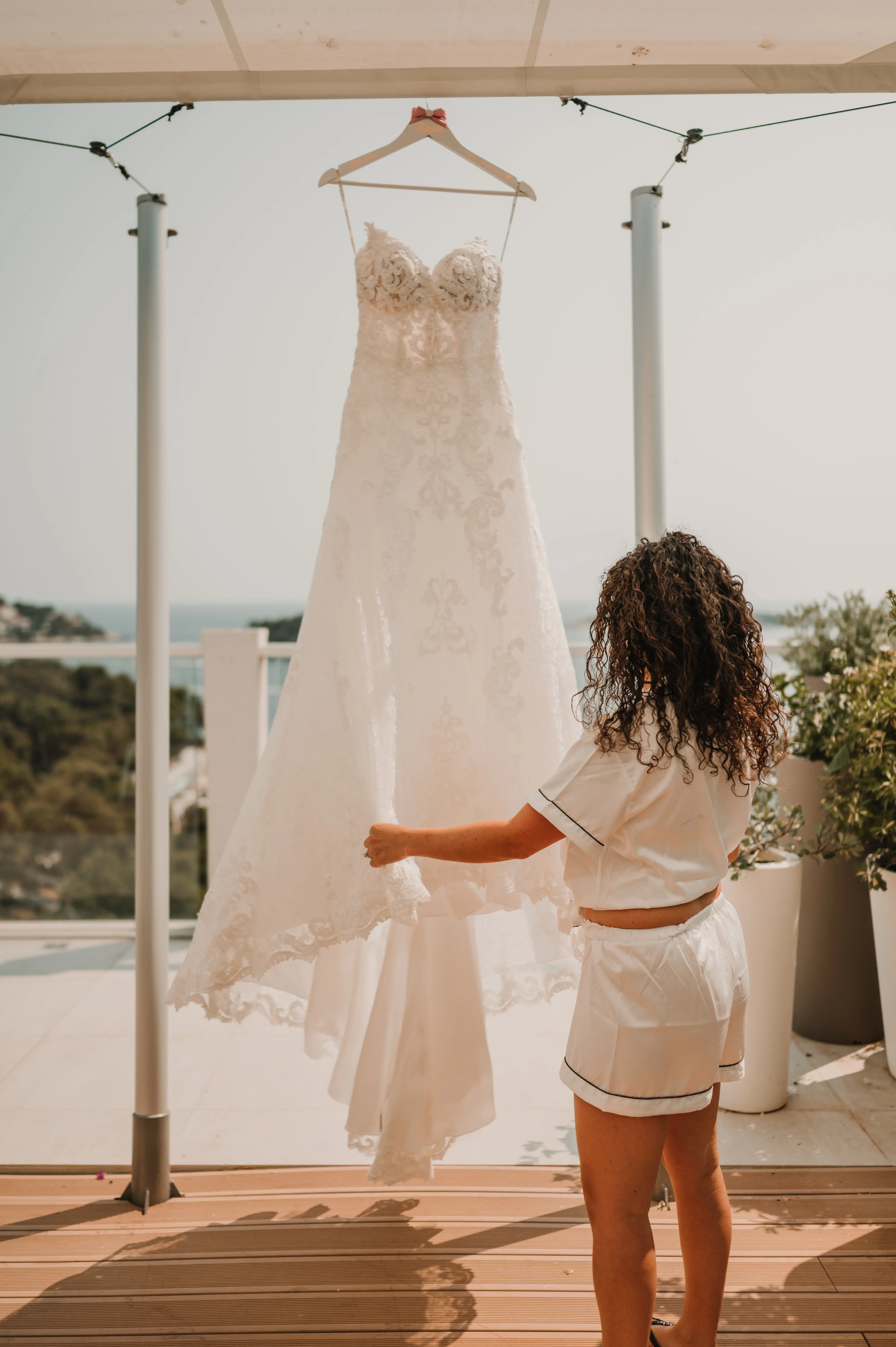 Bride holding lace A-line wedding dress