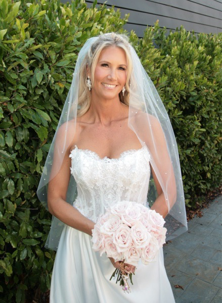 Bride Wearing 3D Floral Wedding Dress Called Takera Lane By Maggie Sottero Holding A Pink Bouquet